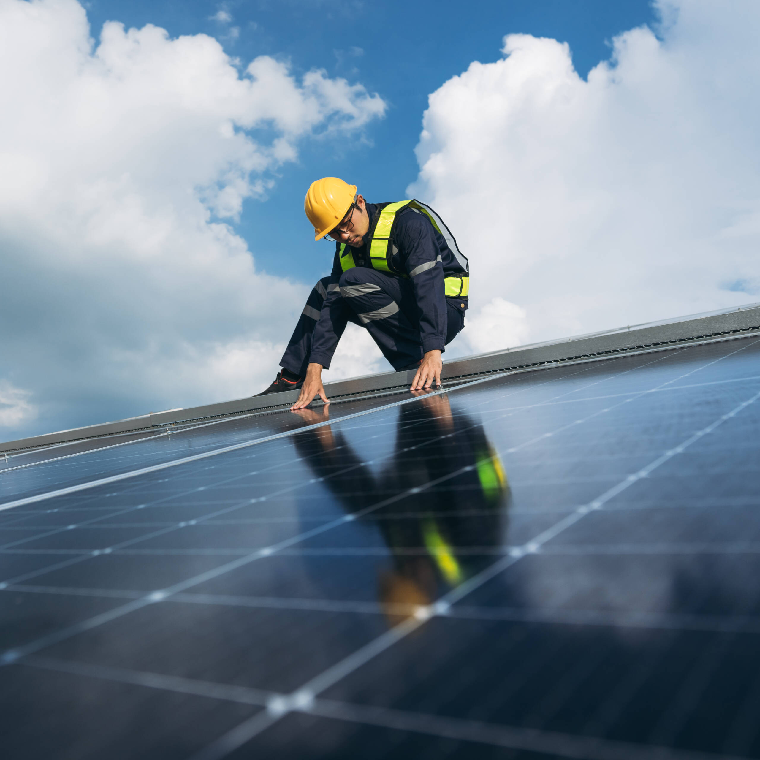 Service engineer checking solar cell on the roof for maintenance if there is a damaged part. Engineer worker install solar panel. Clean energy concept.