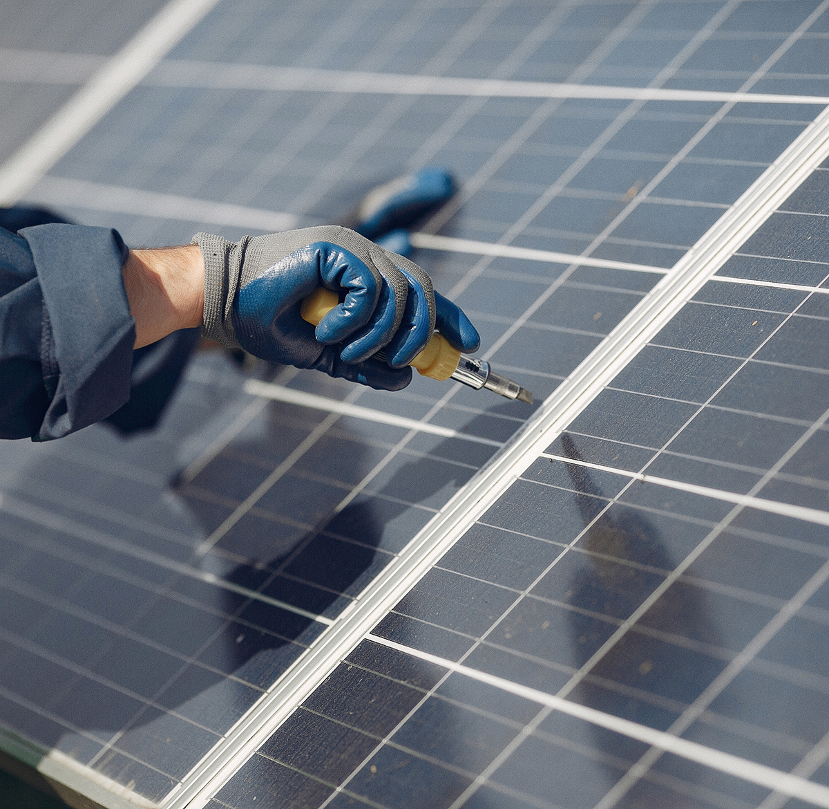 Engineer in a white helmet. Man near solar panel.